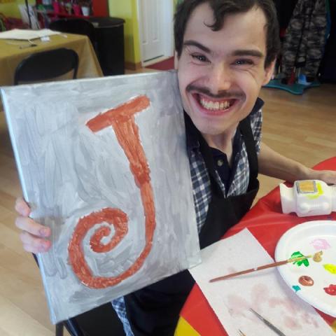 Young man showing his artwork