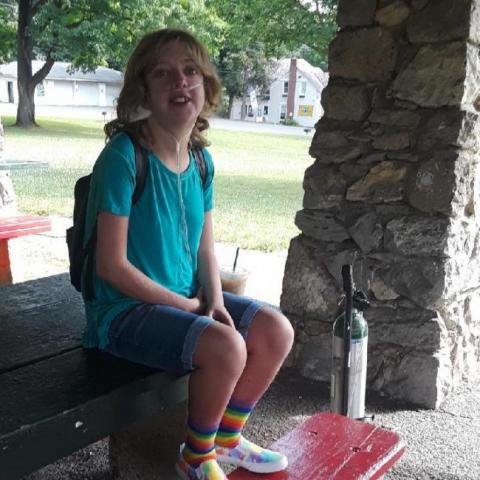 Young lady sitting on a bench